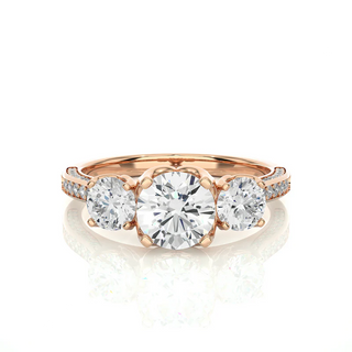 Front view of 2 Ct Round Moissanite Filigree Three Stone Engagement Ring in Rose Gold, highlighting the brilliant center moissanite stone.