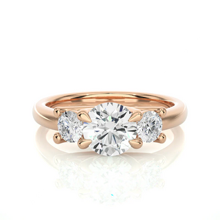 Front view of 2 Carat Round Moissanite Three Stone Engagement Ring in Rose Gold, highlighting the brilliant center moissanite stone.