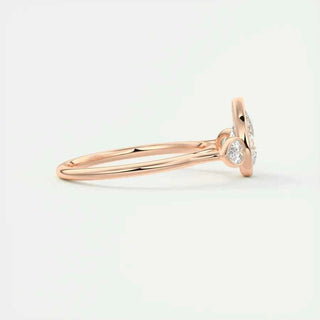 2 Carat Pear Cut Three Stone Bezel Set Moissanite Ring in Rose Gold