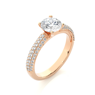 Angled view of 1.50 Ct Moissanite Engagement Ring With Three Row Accents In Rose Gold, showcasing the band and setting.