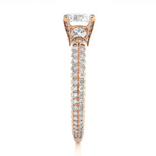 Side profile of 1 Carat Round Shaped Moissanite Engagement Ring With Accents in Rose Gold, highlighting the prong setting.