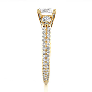 Side profile of 1 Carat Round Moissanite Engagement Ring With Accents in Yellow Gold, highlighting the prong setting.