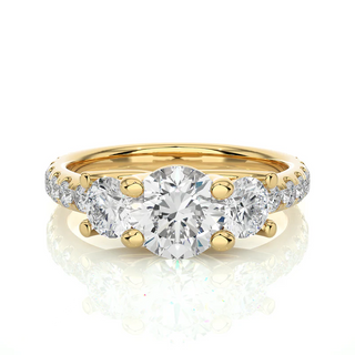 Front view of 2.50 Ct Round Moissanite Trellis Prong Three Stone Engagement Ring Yellow Gold, highlighting the brilliant center moissanite stone.