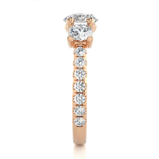 Side profile of 2.50 Carat Round Moissanite Trellis Prong Three Stone Engagement Ring in Rose Gold, highlighting the prong setting.
