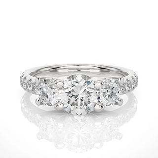 Front view of 2.50 Ct Round Moissanite Trellis Prong Three Stone Engagement Ring in white gold, highlighting the brilliant center moissanite stone.