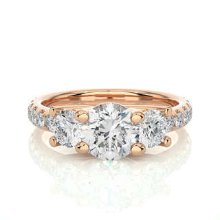 Front view of 2.50 Carat Round Moissanite Trellis Prong Three Stone Engagement Ring in Rose Gold, highlighting the brilliant center moissanite stone.