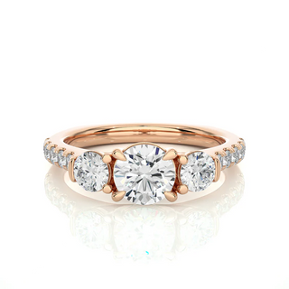 Front view of 2 Carat Round Moissanite Engagement Three Stone Ring In Rose Gold, highlighting the brilliant center moissanite stone.