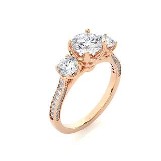 Angled view of 2 Ct Round Moissanite Filigree Three Stone Engagement Ring in Rose Gold, showcasing the band and setting.​