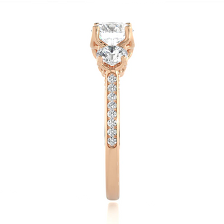 Side profile of 2 Ct Round Moissanite Filigree Three Stone Engagement Ring in Rose Gold, highlighting the prong setting.