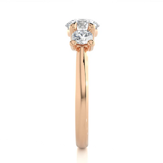 Side profile of 12 Carat Round Moissanite Three Stone Engagement Ring in Rose Gold, highlighting the prong setting.