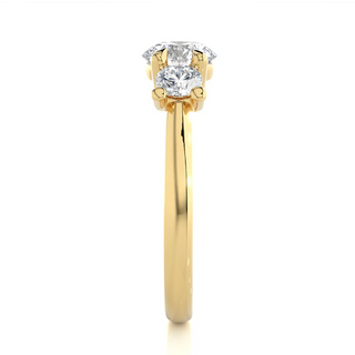 Side profile of 2 Carat Round Moissanite Three Stone Engagement Ring In Yellow Gold, highlighting the prong setting.