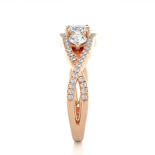 Side profile of 2 Carat Round Moissanite Three Stone Twisted Engagement Ring in Rose Gold, highlighting the brilliant center moissanite stone., highlighting the prong setting.