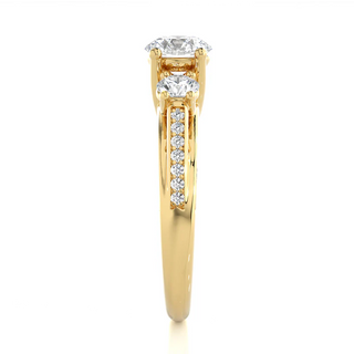 Side profile of 12 Carat Moissanite Three Stone Engagement Ring With Accents in Yellow Gold, highlighting the prong setting.