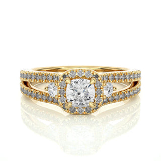 Front view of 2 Carat Cushion Cut Moissanite Three Stone Halo Ring In Yellow Gold, highlighting the brilliant center moissanite stone.
