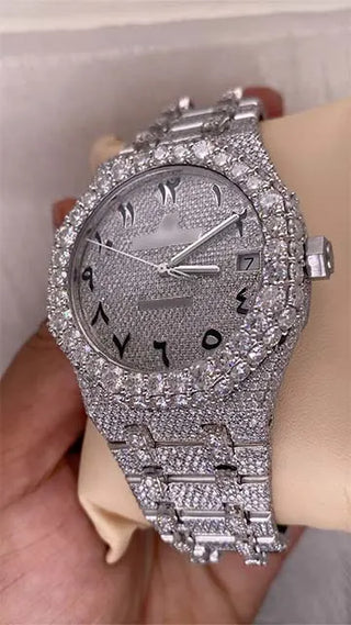 Angled view of a cheap moissanite replica watch featuring a pavé stone dial, Arabic numerals, and fully studded bezel and band.