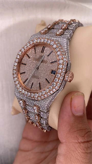 Iced out AP Moissanite Watch with rose gold bezel, shimmering moissanite stones, stainless steel strap, and side date display.
