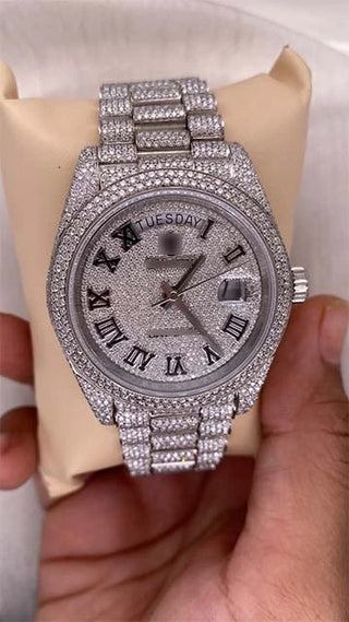 Front view of one of the best moissanite watches featuring white gold accents, moissanite stones, and stainless steel strap.