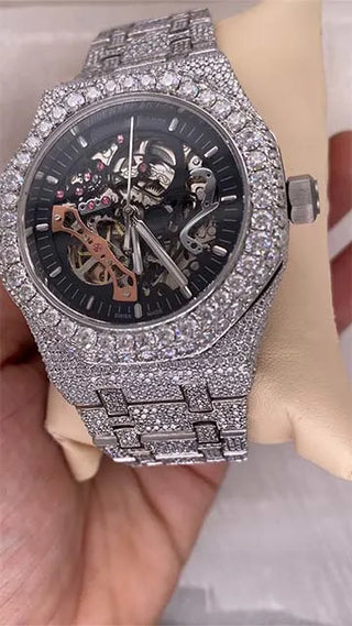 Angled view of a cheap moissanite skeleton watch with visible gears and stone-studded case and bracelet for a shiny look.