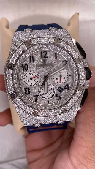 Front view of a men’s moissanite watch with full diamond setting, chronograph dial, and blue strap, offered for sale.