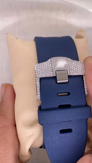 Back view of a men’s moissanite watch with a blue strap and detailed case design, held in hand for display.