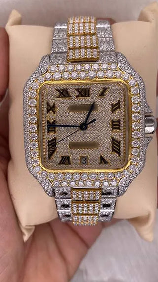 Front view of a moissanite watch for men featuring a fully iced dial, Roman numerals, and a two-tone metal band.