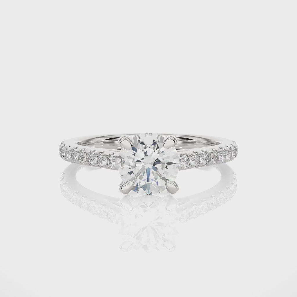 White gold four-prong cathedral moissanite engagement ring in video showcasing brilliance, angles, and detailed craftsmanship.