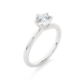 Angled view of 1.50 Carat Round Cut Moissanite Solitaire Engagement Ring In Silver, showcasing the band and setting.​