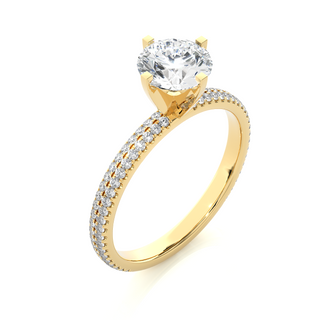 Angled view of 1.50 Ct Moissanite Engagement Ring With Accents In Yellow Gold, showcasing the band and setting.​