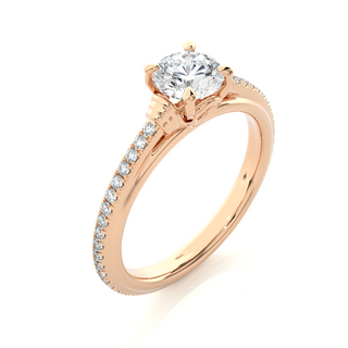 Angled view of 1.50 Ct Round Cut Moissanite French V-Split Engagement Ring In Rose Gold, showcasing the band and setting.​