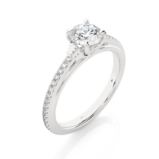 Angled view of 1.50 Ct Round Cut Moissanite French V-Split Engagement Ring In White Gold, showcasing the band and setting.​