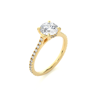 Angled view of 1.50 Ct Round Moissanite Hidden Halo Engagement Ring In Yellow Gold, showcasing the band and setting.​