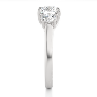 Side profile of 1.50 Ct Round Moissanite Three Stone Engagement Ring In Silver, highlighting the brilliant center moissanite stone., highlighting the prong setting.