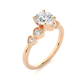 Angled view of 1.50 Ct Round Shape Moissanite Five Stone Engagement Ring In Rose Gold, showcasing the band and setting.​