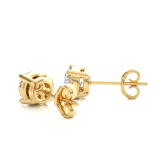 Angled view of 1 Carat Four Prong Round Cut Moissanite Stud Earrings in Yellow Gold, showing depth and radiant sparkle.