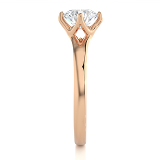 Side profile of 1 Carat Round Moissanite Split Shank Solitaire Engagement Ring In Rose Gold, highlighting the prong setting.