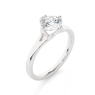 Angled view of 1 Carat Round Moissanite Split Shank Solitaire Engagement Ring In Silver, showcasing the band and setting.​
