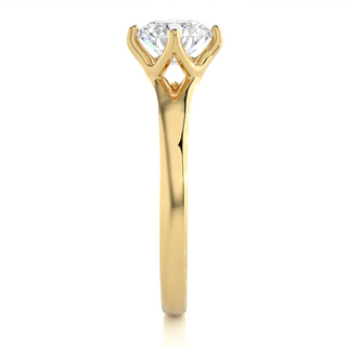 Side profile of 1 Carat Round Moissanite Split Shank Solitaire Engagement Ring In Yellow Gold, highlighting the prong setting.