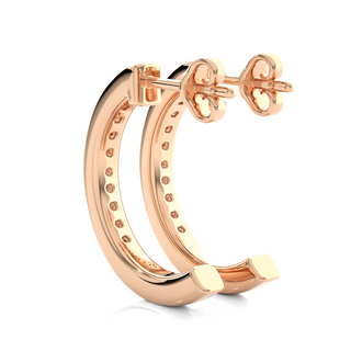 angled view of 1 Carat Round Shape Moissanite C Hoop Earrings In Rose Gold, with bright sparkle in channel setting.