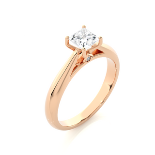 Angled view of 1 Ct Princess Moissanite Solitaire Engagement Ring In Rose Gold, showcasing the band and setting.​