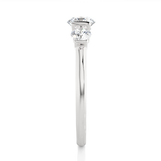 Side profile of 2 Carat Round Cut Moissanite Three Stone Engagement Ring In Silver, highlighting the brilliant center moissanite stone., highlighting the prong setting.