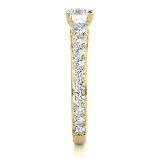 Side profile of 2 Ct Bridge Set Moissanite Engagement Ring With Accent In Yellow Gold, highlighting the prong setting.