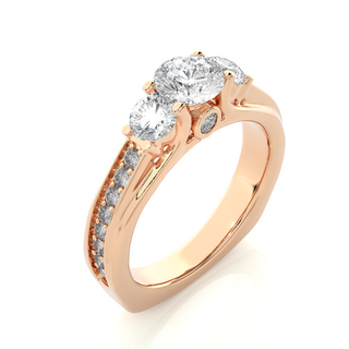 Angled view of 2 Ct Round Moissanite Three Stone Engagement Ring In Rose Gold showcases the band and setting.​