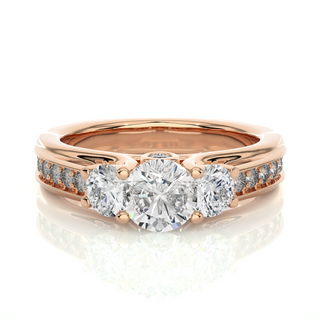 Front view of 2 Ct Round Moissanite Three Stone Engagement Ring In Rose Gold, highlighting the brilliant center Moissanite stone.