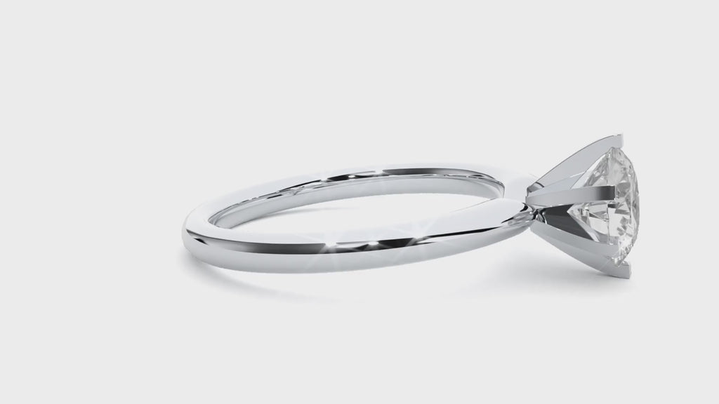 Video of a white gold solitaire engagement ring with a round brilliant moissanite in a 6-prong setting, displayed on a hand.
