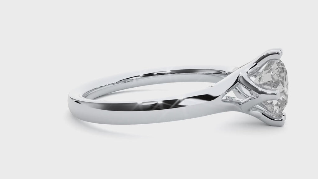 Video of a white gold solitaire engagement ring featuring a round brilliant moissanite in a classic 6-prong setting.