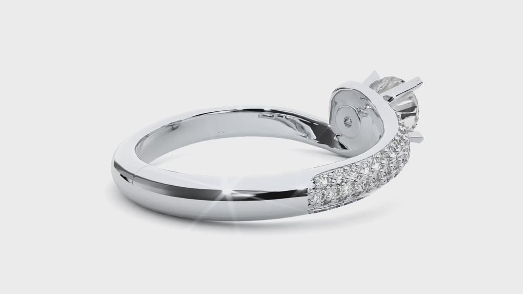 Video of a white gold engagement ring with a round brilliant moissanite set in a classic solitaire 6-prong setting on a smooth band.
