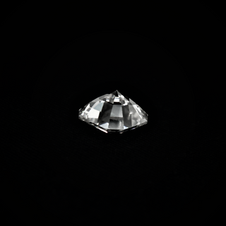 Back view of an Asscher cut Moissanite loose stone placed on a black surface.