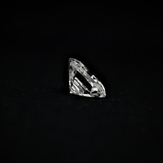 Side view of an Asscher cut Moissanite gemstone showcasing its step-cut facets and clarity against a dark background.