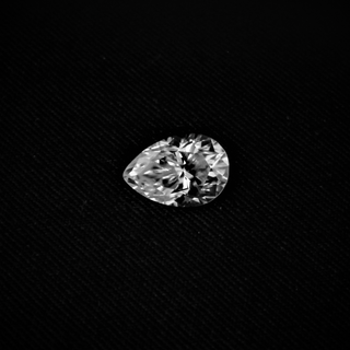 Side view of pear cut moissanite—teardrop shape with sharp facets that shine brightly from every angle.