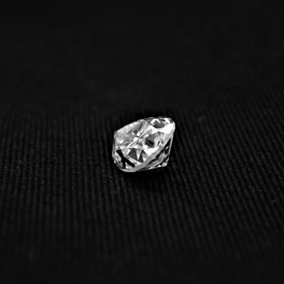 Back view of pear cut moissanite—deep facets and sharp edges reflect light with a bold and bright sparkle.